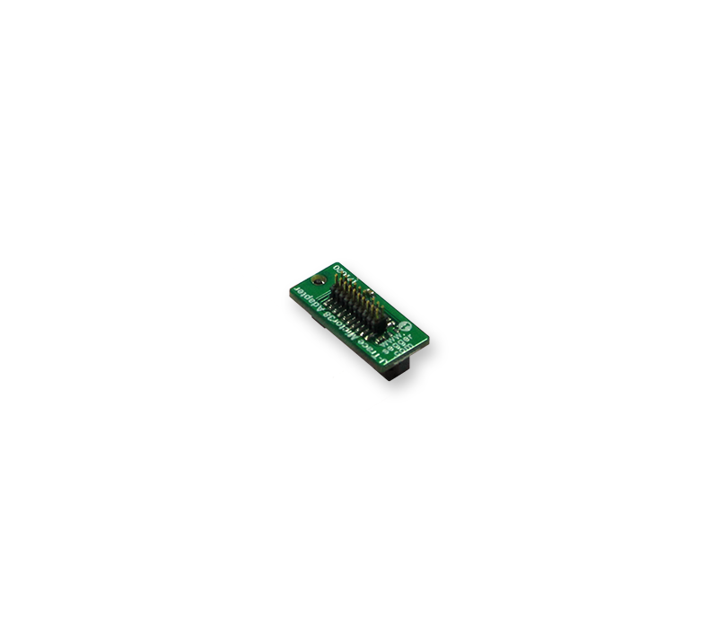 J-Trace Mictor 38 Adapter A small green electronic circuit board featuring a row of metallic pins. The board is designed for connectivity, with text and symbols printed on its surface, indicating its purpose in electronic applications. The background is plain white.